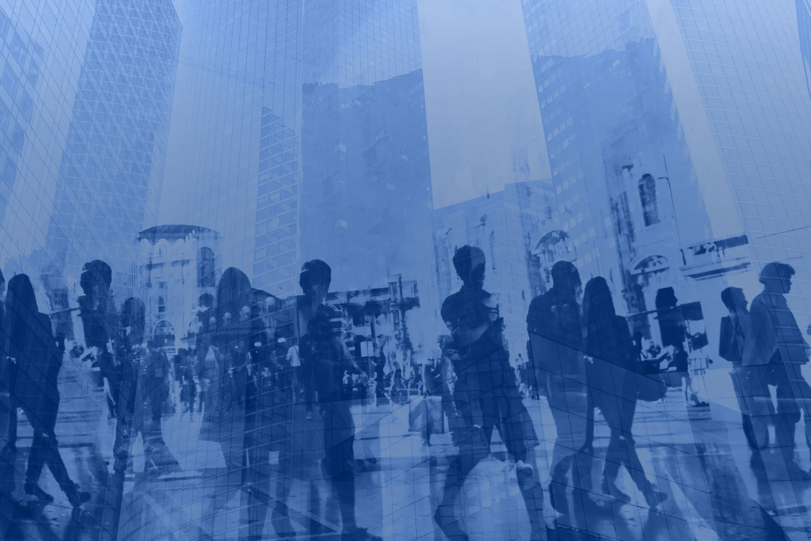 A crowd of people moving through a city of glass towers, double exposed